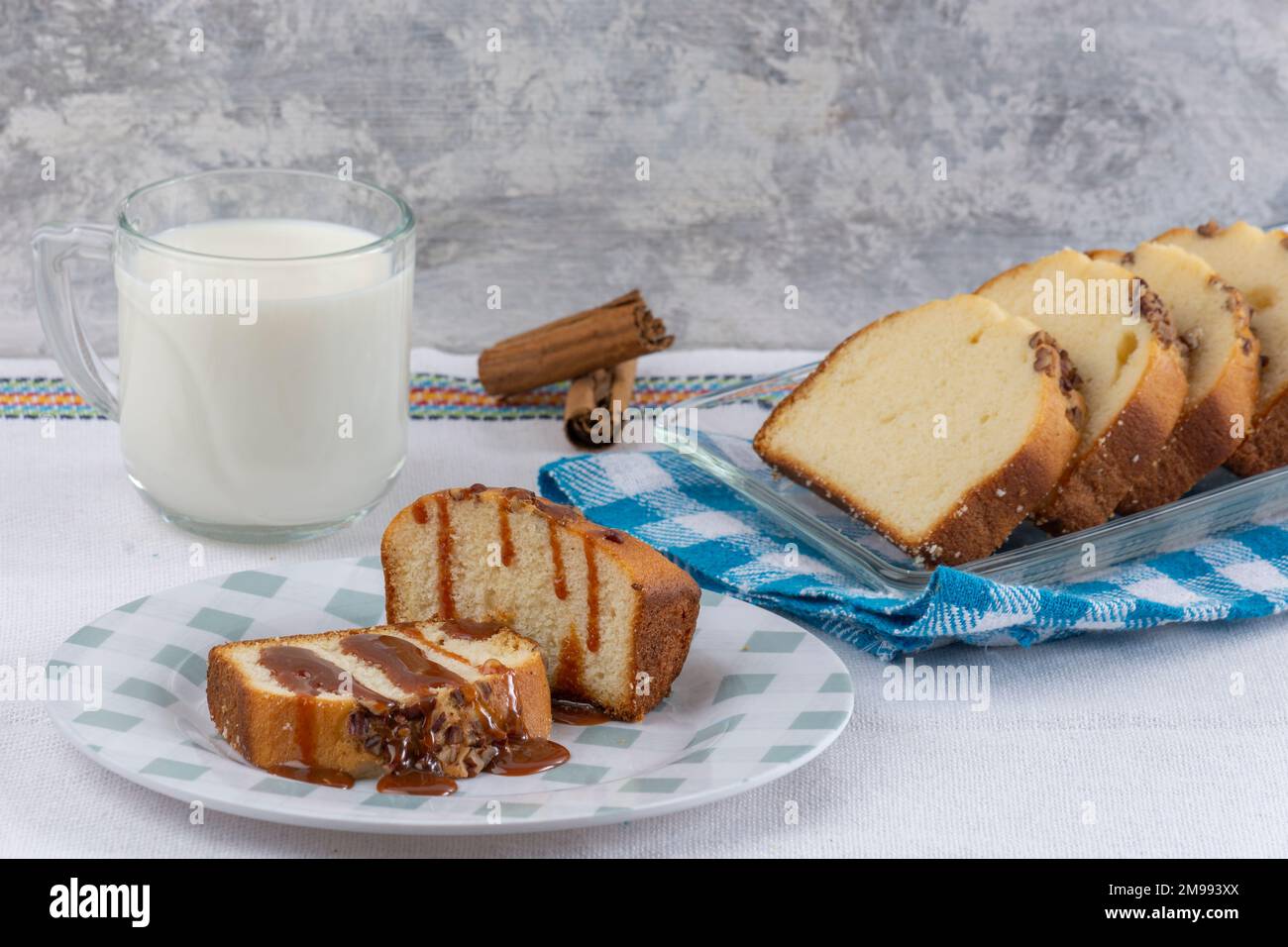 due fette di pane di noce con cajeta su un tavolo accompagnato da un bicchiere di latte. Foto Stock