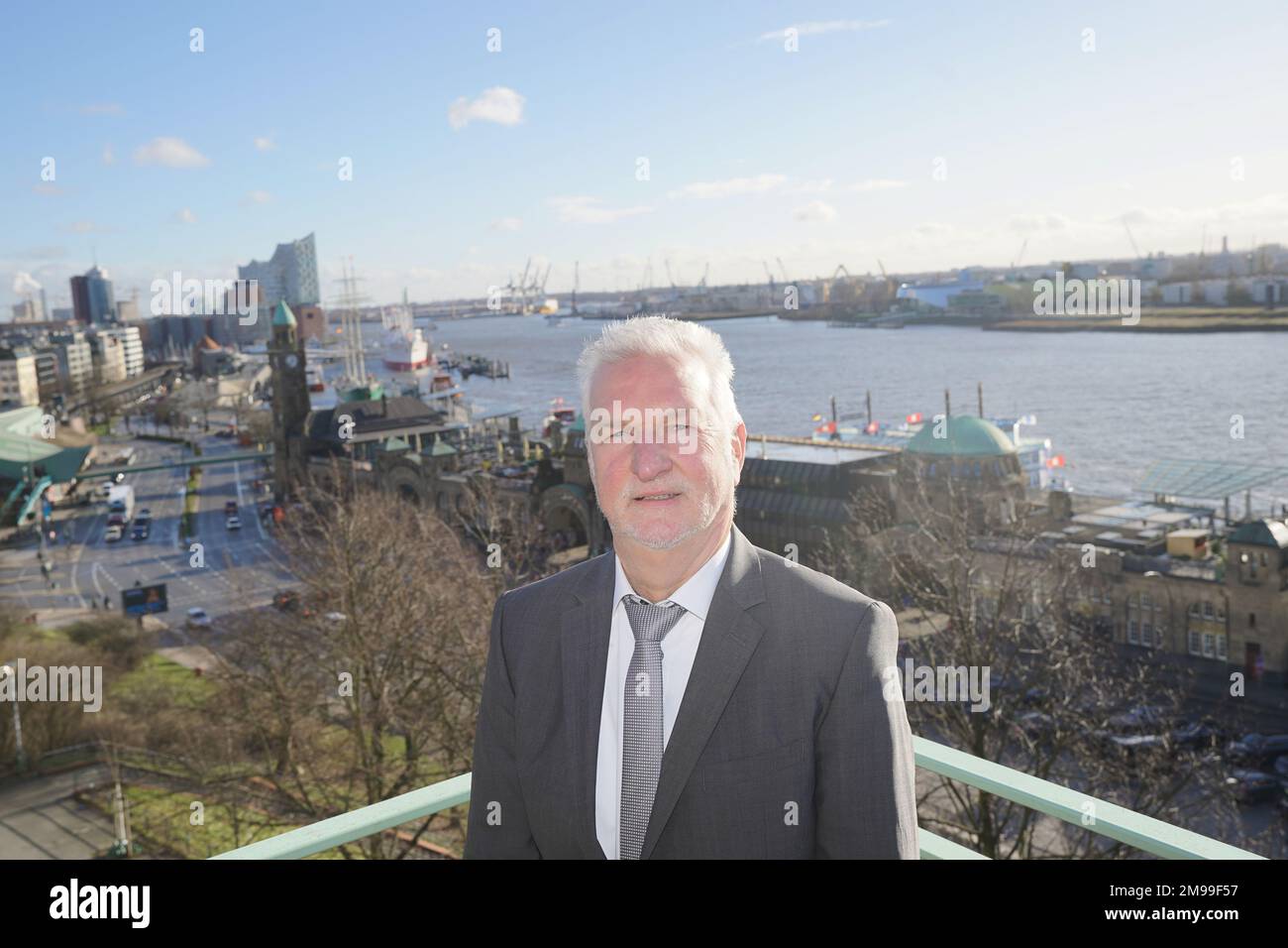 17 gennaio 2023, Amburgo: Bernd Brügge, capo del Dipartimento di Oceanografia e vicepresidente della BSH, si trova su un balcone dopo la conferenza stampa annuale dell'Agenzia federale marittima e idrografica (BSH). Il Landungsbrücken, il Überseebrücke e l'Elbphilharmonie sono visibili sullo sfondo. La BSH non vede alcuna possibilità di accelerare il processo di approvazione del dumping del limo Elbe nella zona economica esclusiva. Amburgo è sotto una certa pressione quando si tratta di smaltimento del limo, perché l'accordo sullo scarico del limo in mare marker E3 vicino a Helgoland è limitato nel tempo e la ne Foto Stock
