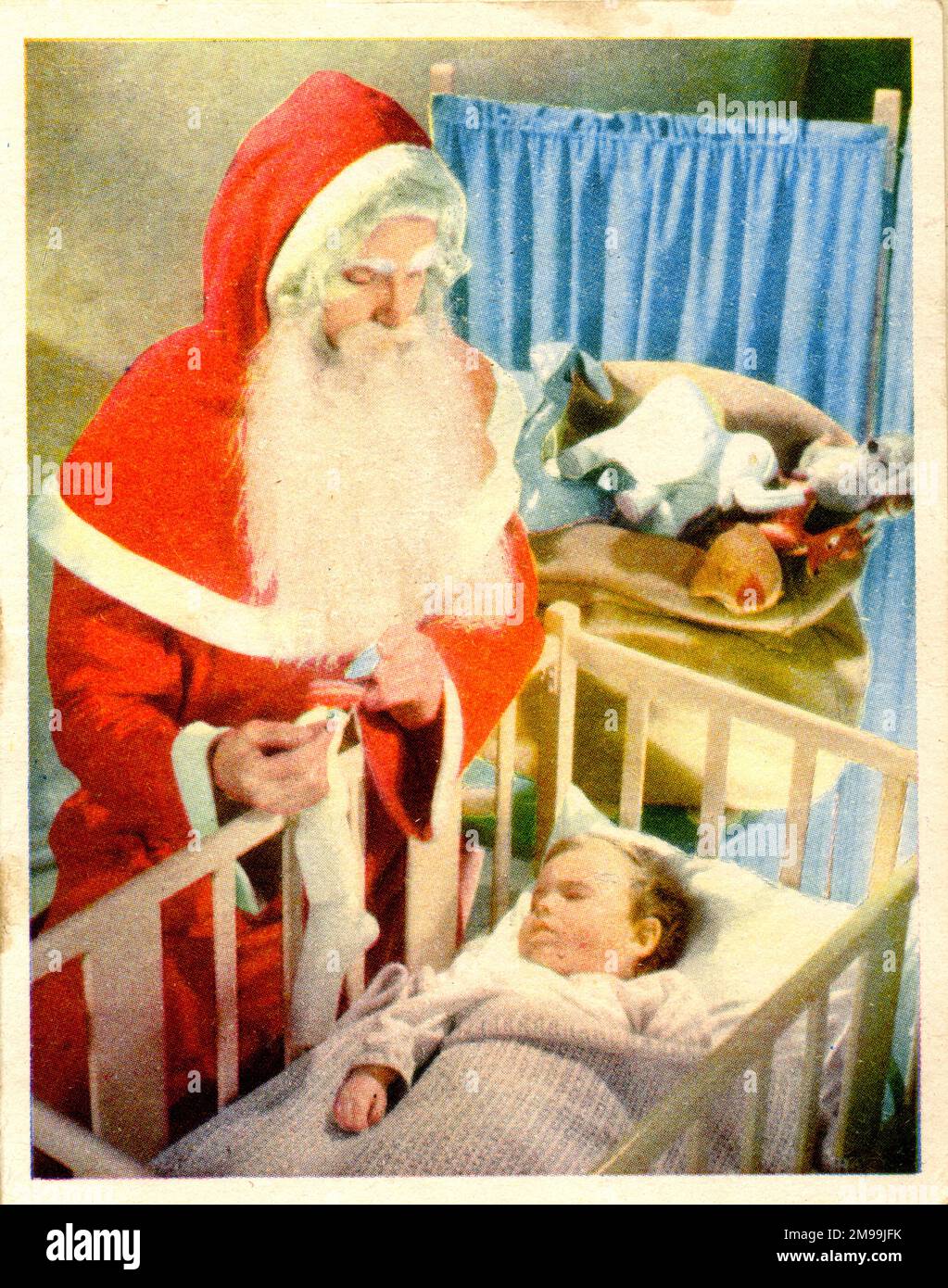 Biglietto di Natale, Babbo Natale in visita bambino in culla. Foto Stock