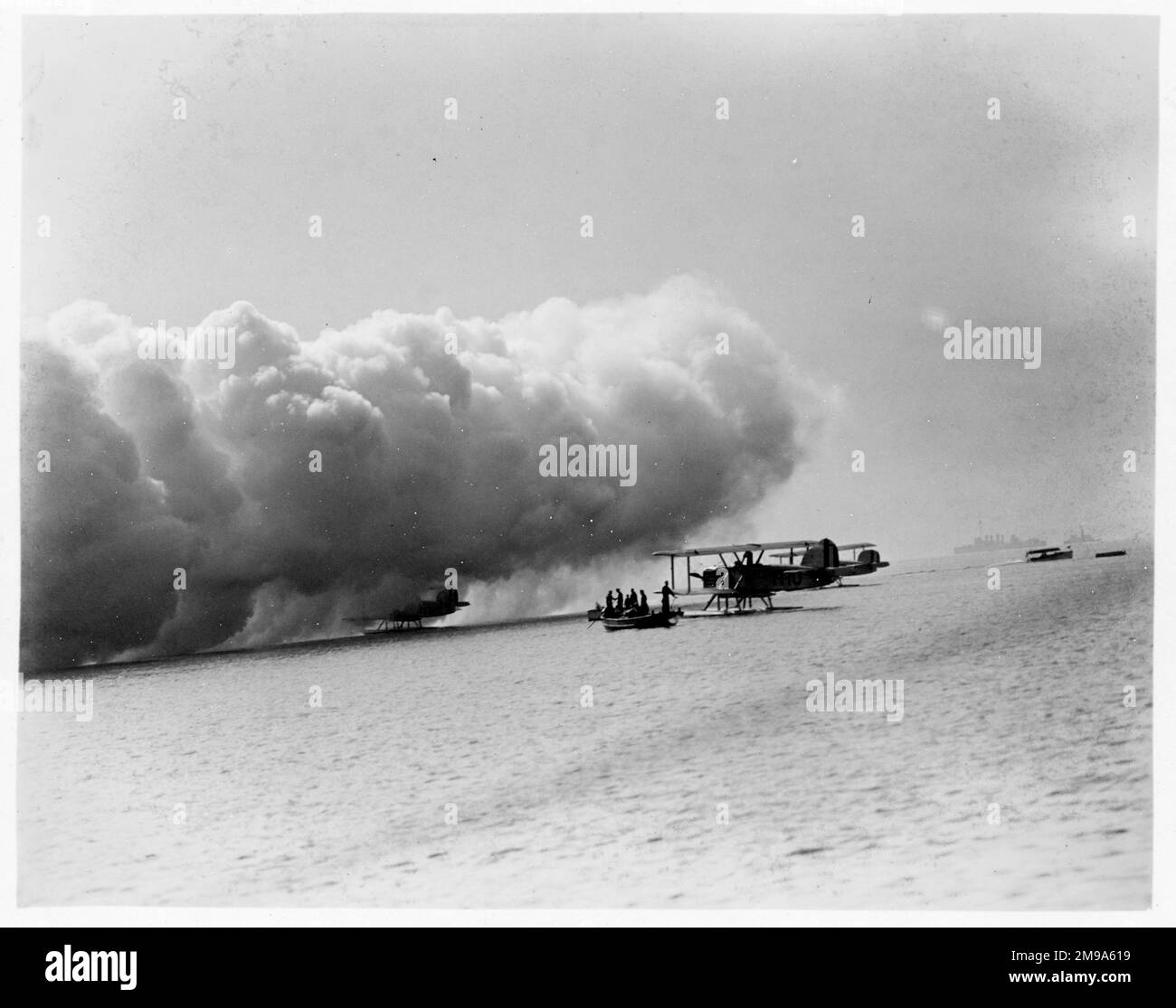 United States Navy - Douglas DT 1-T-10 e altri due aerei float-plane bombardieri siluro di VT-1, durante gli esercizi, con una cortina di fumo che rotola dentro. Foto Stock