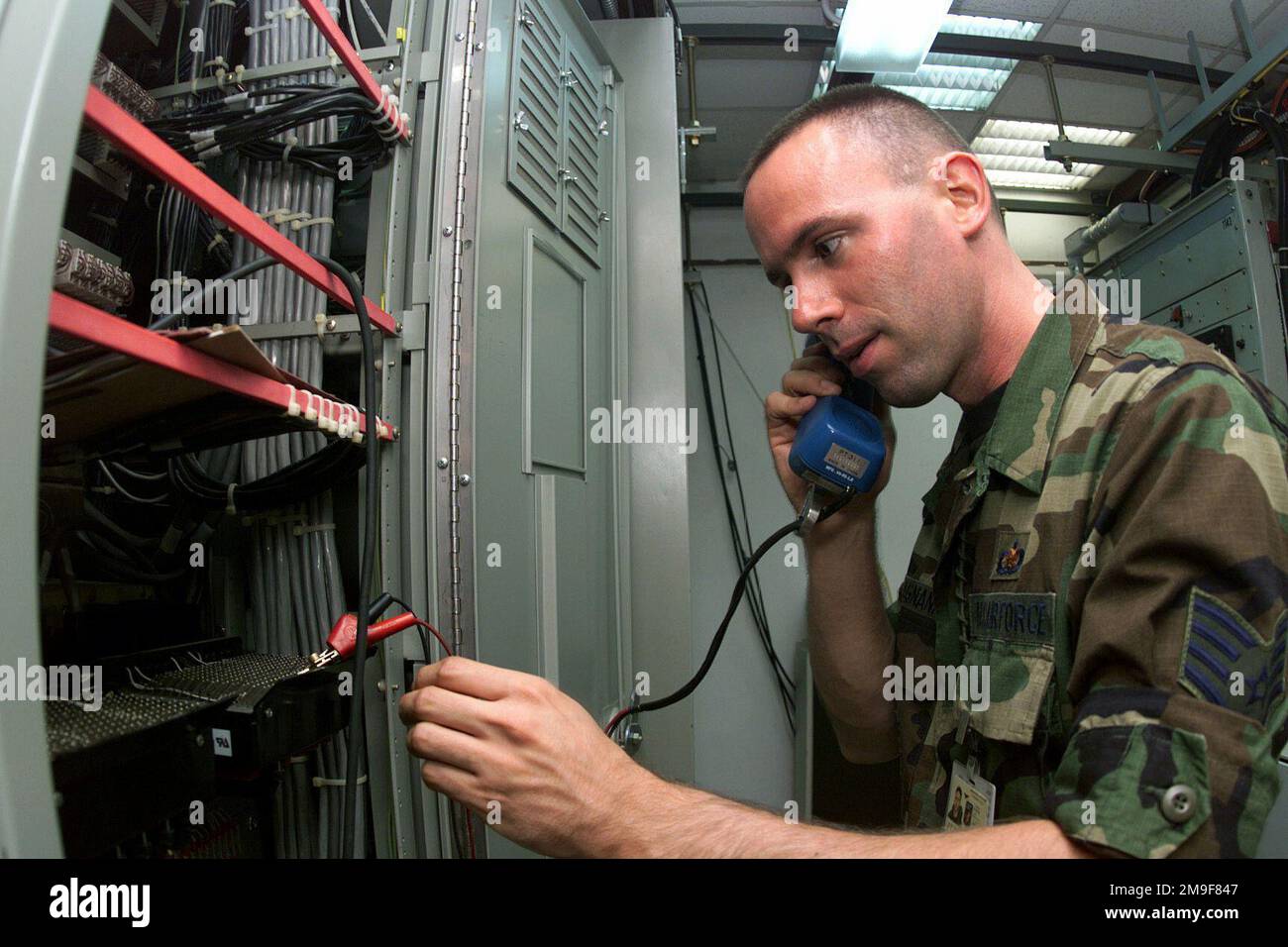 Profilo lato sinistro ripresa da vicino media come il sergente dell'aeronautica statunitense Patrick Magnani, 831st Munizioni supporto Squadron Ghedi Air base, Italia verifica i toni su una linea telefonica. Base: Ghedi Air base Nazione: Italia (ITA) Foto Stock