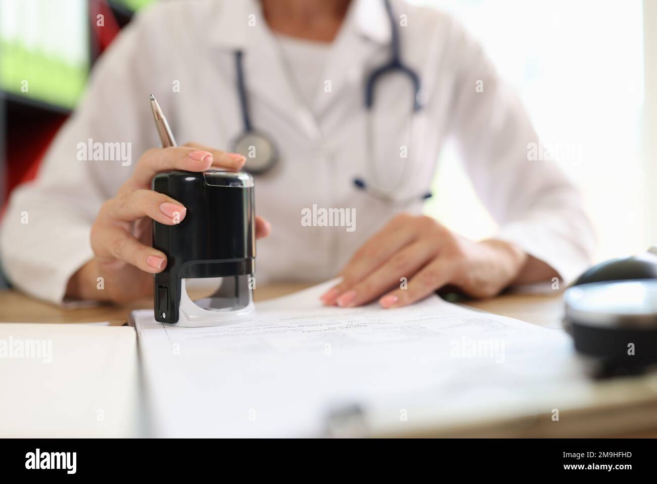 Medico di sesso femminile in ufficio medico sta stampando documenti medici. Foto Stock