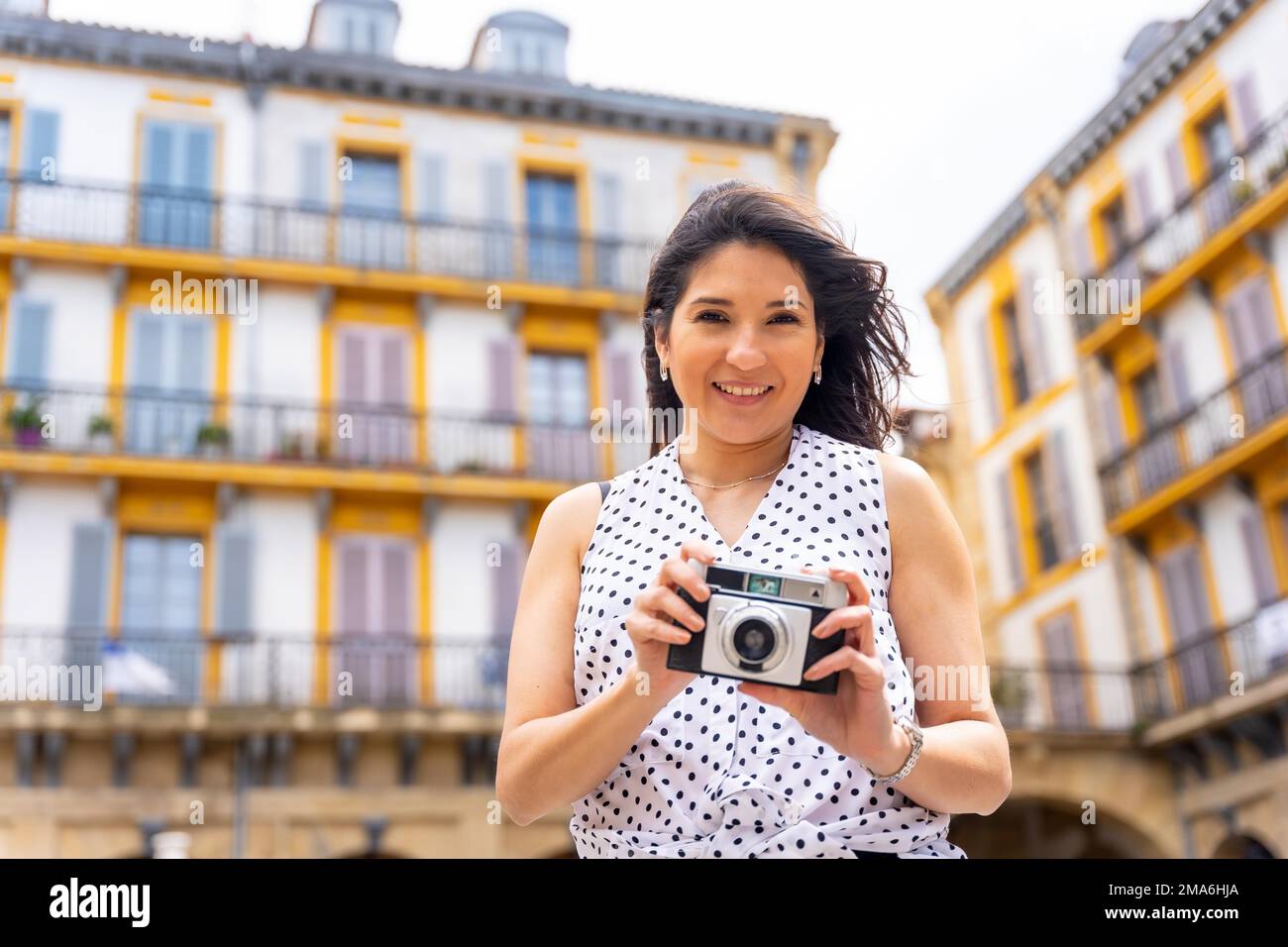 Donna turistica che visita la città guardando le foto di viaggio, godersi le vacanze estive, il concetto di viaggiatore femminile e la creazione di contenuti digitali Foto Stock