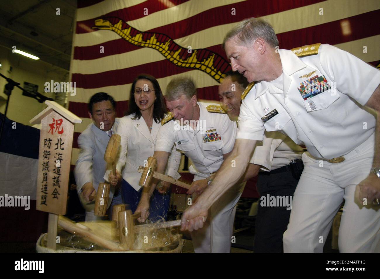 060704-N-3136P-104. [Complete] Scene Caption: US Navy (USN) Ammiraglio (ADM) Gary Roughead (terzo da sinistra), Comandante, US Pacific Fleet (USPACFLT), e USN Rear Admiral (RADM) James D. Kelly (destra), Comandante, US Naval Forces Giappone, accompagnano i funzionari locali del governo giapponese, mentre rompono la copertura di un sake giapponese, Jug Durante una cerimonia di accoglienza del giorno dell'Indipendenza tenuta a bordo della US Navy (USN) Aircraft Carrier USS KITTY HAWK, (CV 63) a Otaru, Giappone (JPN). Mentre sei in porto, I marinai DI KITTY HAWK avranno la possibilità di visitare, fare shopping, praticare attività ricreative e partecipare ai comuni Foto Stock