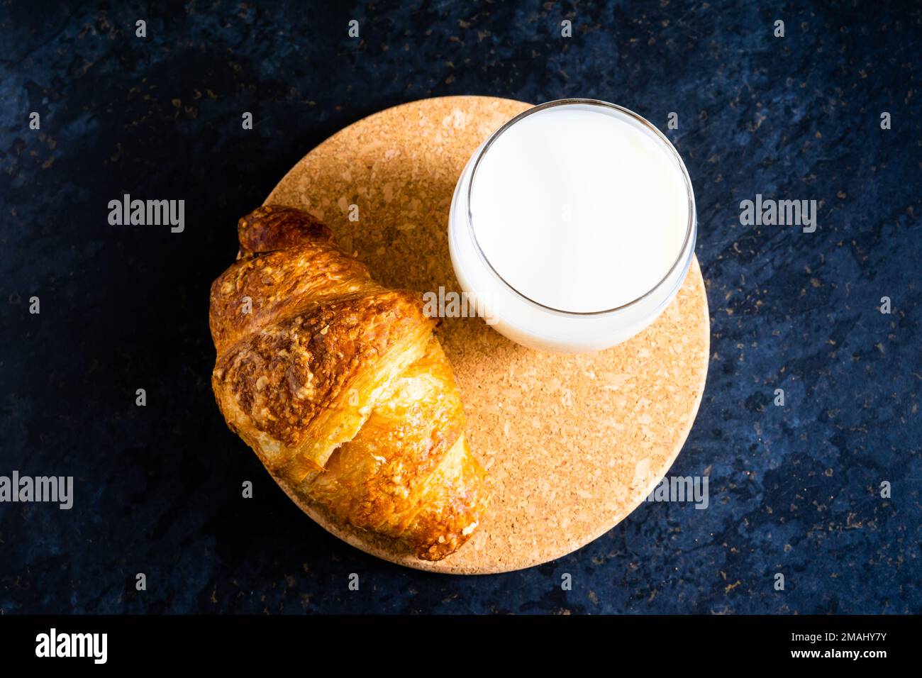 Pane bianco fresco e latte in vetro bianco su fondo di tavola in pietra nera. Vista dall'alto e Studio shot Foto Stock