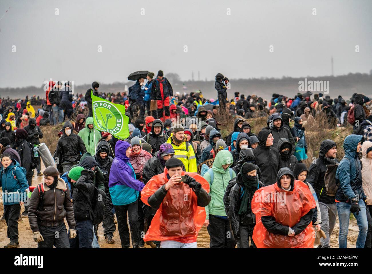 Molte migliaia di dimostranti marciano ai margini della miniera a cielo aperto di Garzweiler dopo una protesta contro la demolizione del villaggio lignita di Lüt Foto Stock