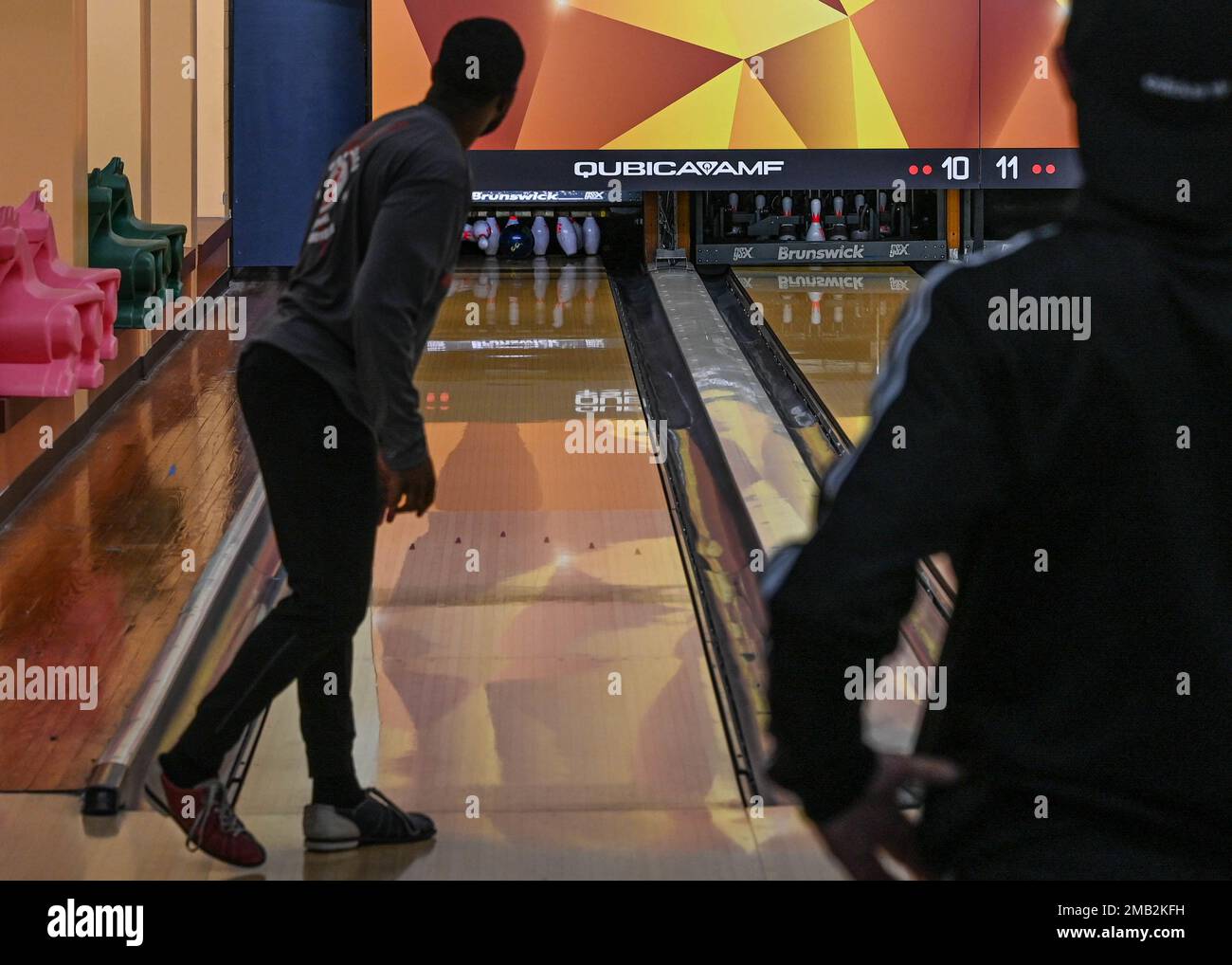 NEGLI STATI UNITI Air Force Airman guarda i birilli di bowling cadere durante i Giochi Crossbow alla base comune Langley-Eustis, Virginia, 10 giugno 2022. I Giochi Crossbow sono una competizione annuale tra tutti gli squadroni su JBLE e mette alla prova le loro abilità atletiche e cameratismo, promuovendo al contempo l'esprit de Corps. Foto Stock