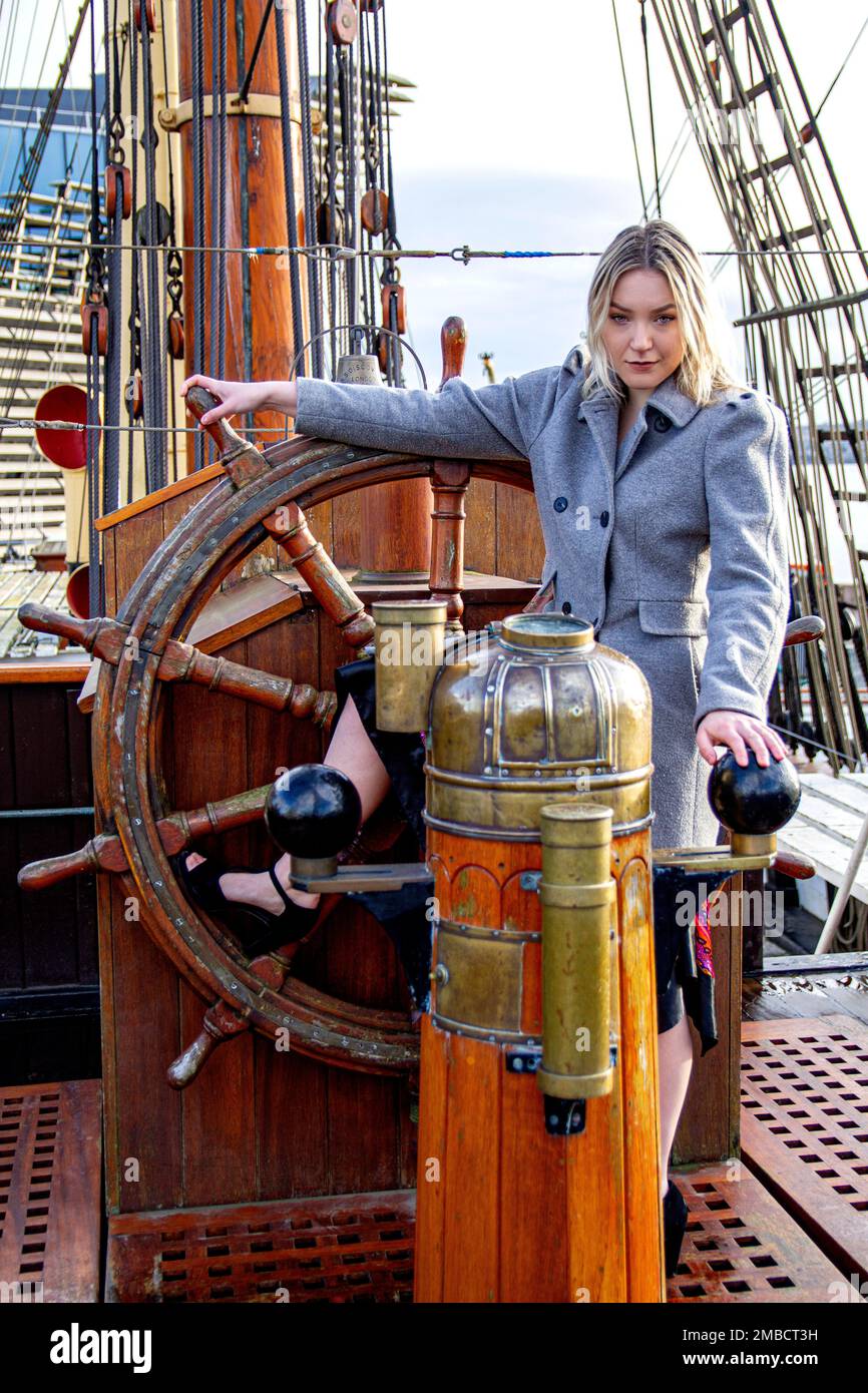 Hayleigh Young, una bella e alla moda donna posa per una fotografia a bordo della nave RRS Discovery in una giornata invernale ghiacciata a Dundee, in Scozia Foto Stock