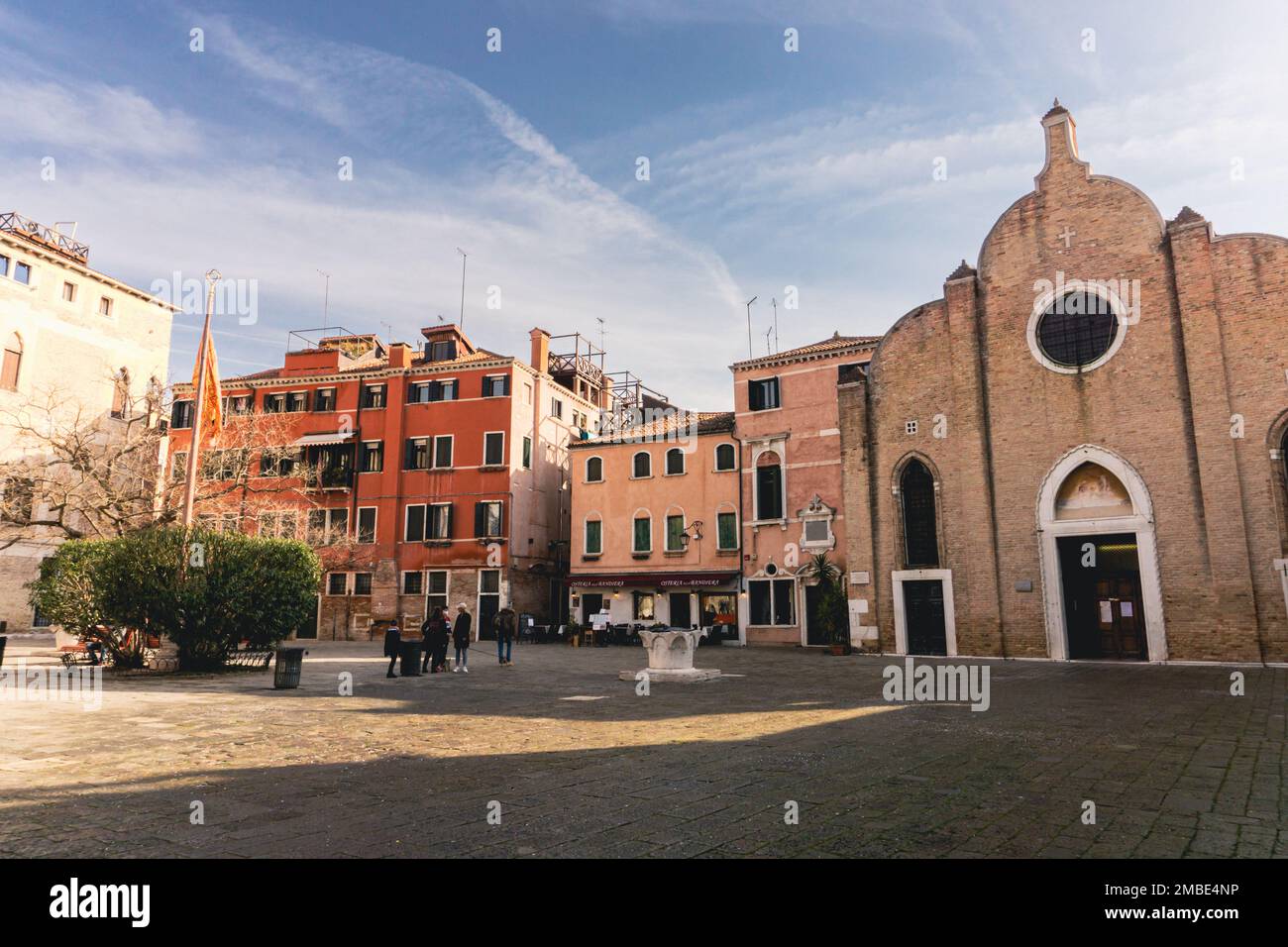 Vista sulla piazza di campo Bandiera e Moro a Venezia con poche persone che si mescolano sotto un cielo azzurro e soleggiato Foto Stock