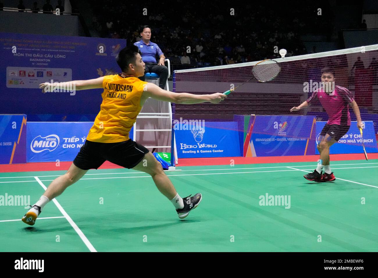 Thailand's Kunlavut Vitidsarn, left, competes against Malaysia's Kok