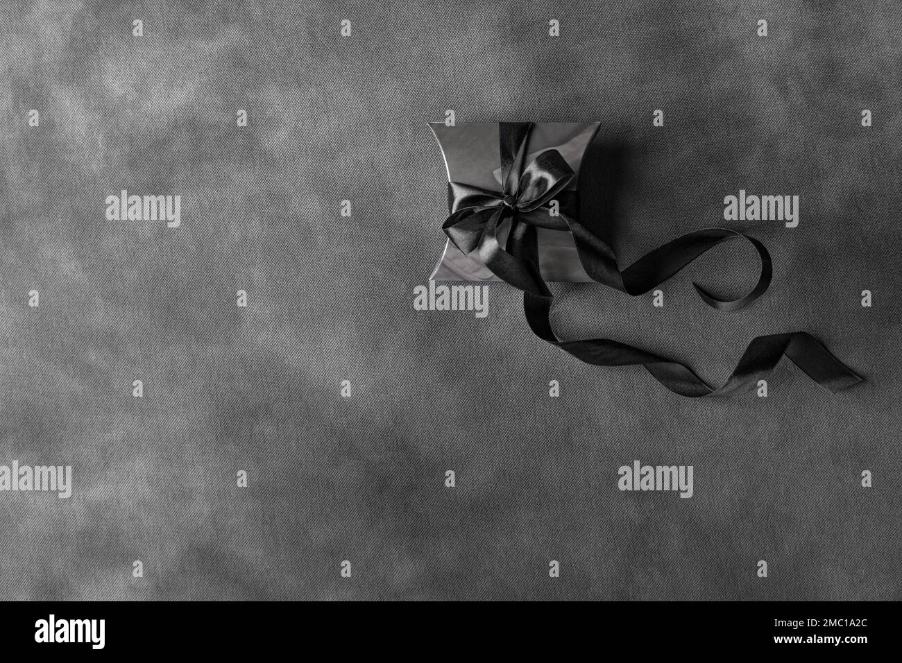 Scatola regalo nera su sfondo scuro. Foto Stock