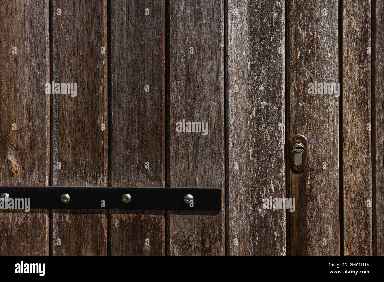 Particolare di vecchia porta rustica in legno con chiavistello Foto Stock