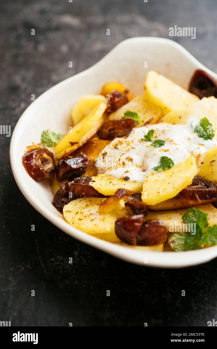 Pastinaca saltata con datteri e yogurt piccante di soia Foto Stock