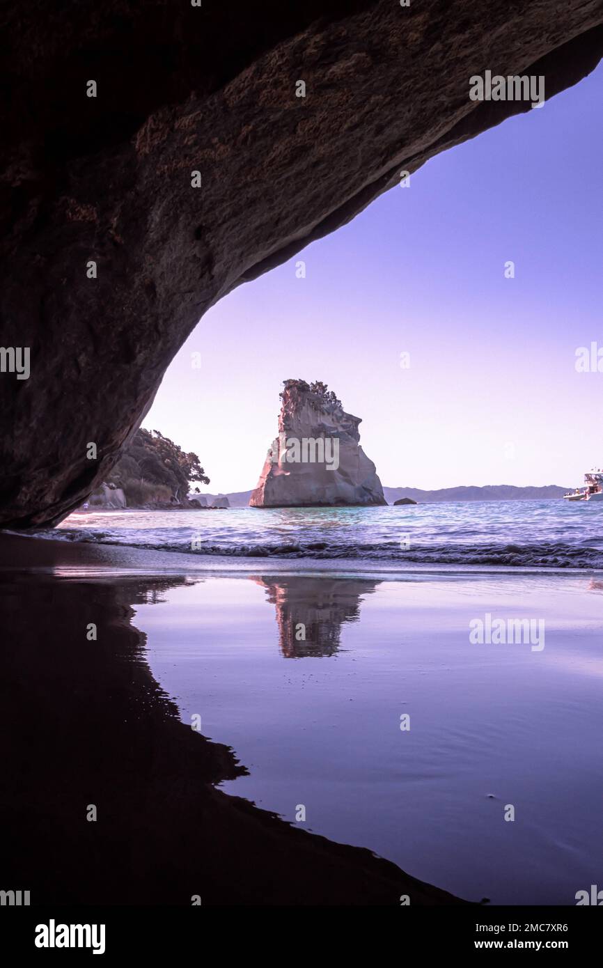 Una vista panoramica attraverso l'arco di roccia verso te Hoho Rock in Cathedral Cove, Nuova Zelanda Foto Stock