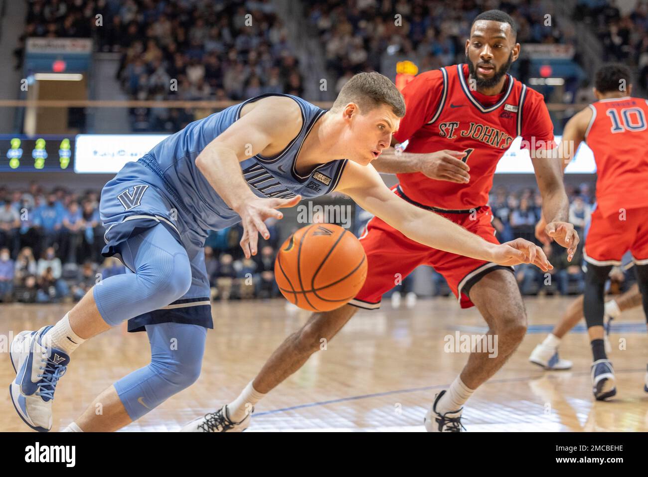 Villanova guard Chris Arcidiacono, left, falls after being fouled by St. John's forward Aaron Wheeler (1) during the first half of an NCAA college basketball game, Saturday, Jan. 29, 2022, in Villanova, Pa. (AP Photo/Laurence Kesterson) Foto Stock