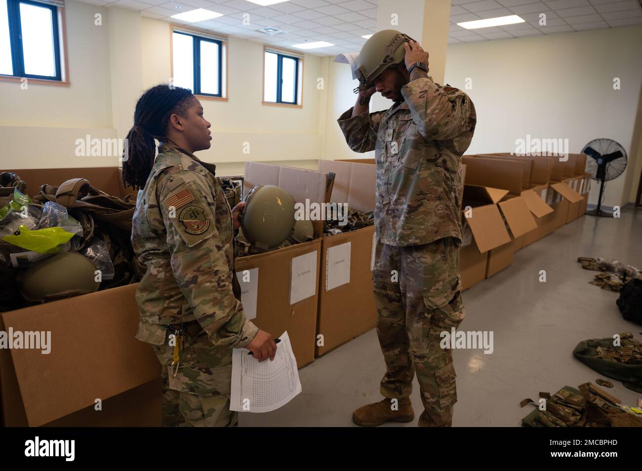 Personale. Dominique McCreary, 8th forze di sicurezza Squadron ufficiale non commissionato responsabile della fornitura, controlla il personale. Trenton Collins, 8th SFS base Defence Operations Center controller, provato su un casco balistico su Kunsan Air base, Repubblica di Corea, 29 giugno 2022. McCreary ha ricordato al Wolf Pack di cogliere ogni opportunità per saperne di più sul significato di Pride Month e non per considerare questo mese come un altro mese che dobbiamo celebrare. STATI UNITI Foto Air Force di Senior Airman Akeem K. Campbell) Foto Stock