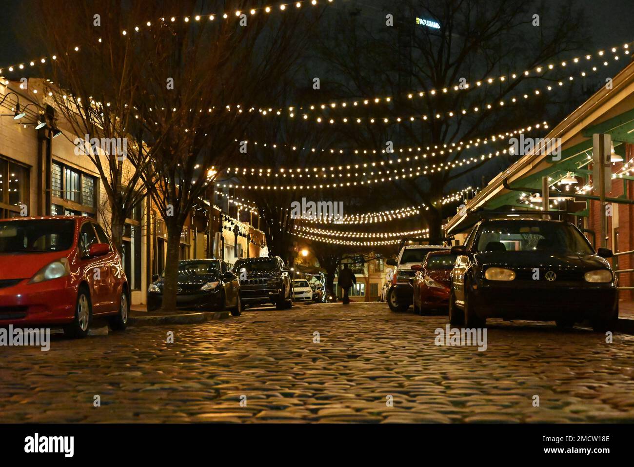 Strada acciottolata di notte nel quartiere finanziario City Market nel centro di Raleigh, North Carolina. Foto Stock