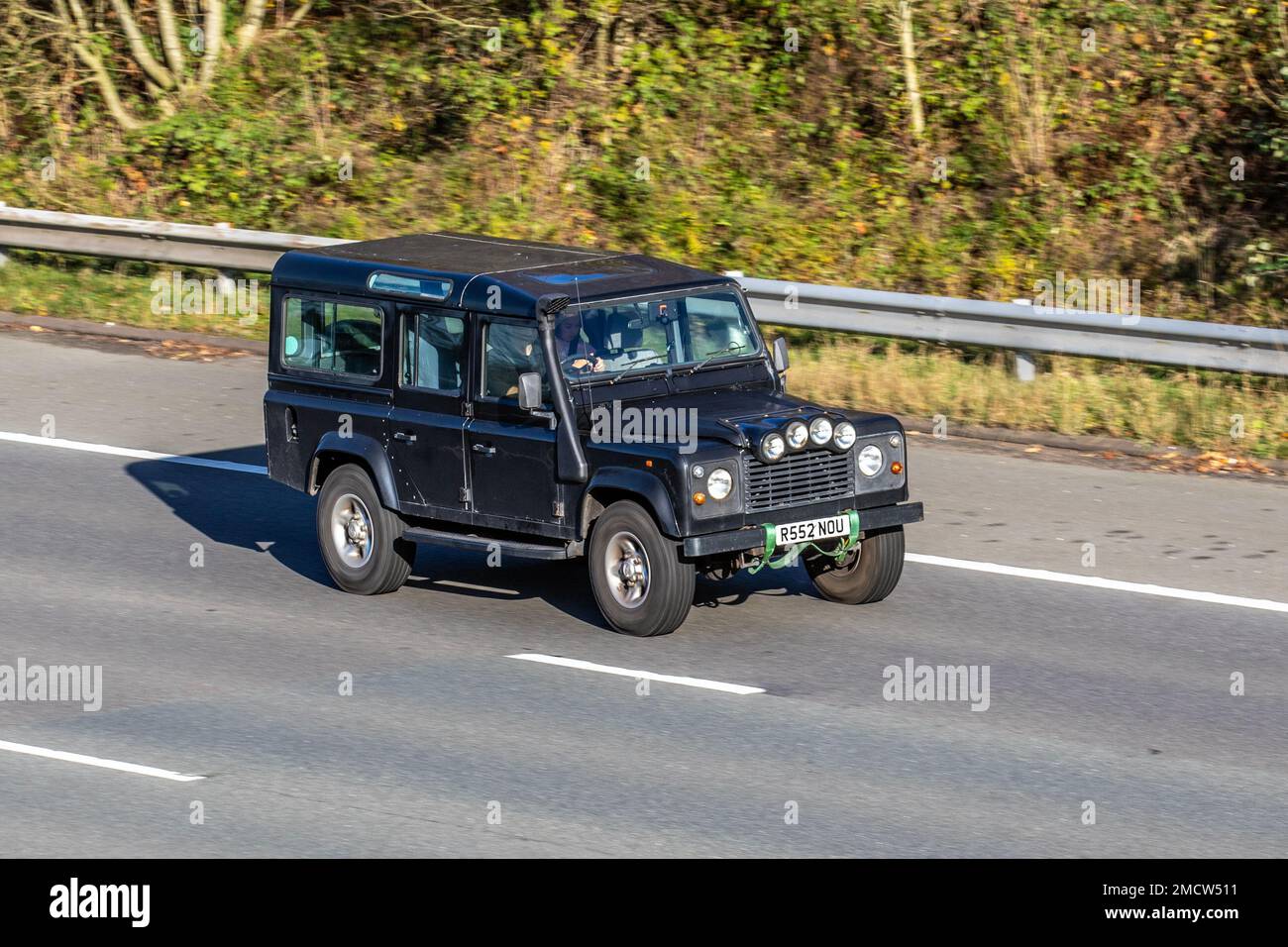 1997, 90s, novanta Black British LAND ROVER DEFENDER TDi 2495cc Diesel 4x4 veicolo fuoristrada; viaggiando sull'autostrada M61, Regno Unito Foto Stock