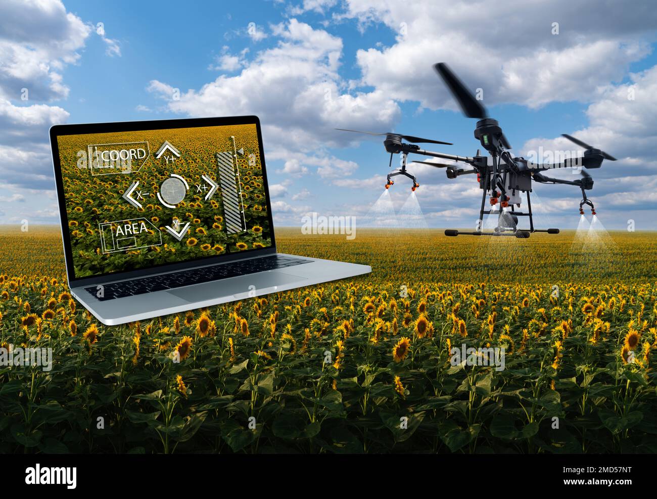 Irroratrice a droni e computer portatile. Azienda agricola intelligente Foto Stock