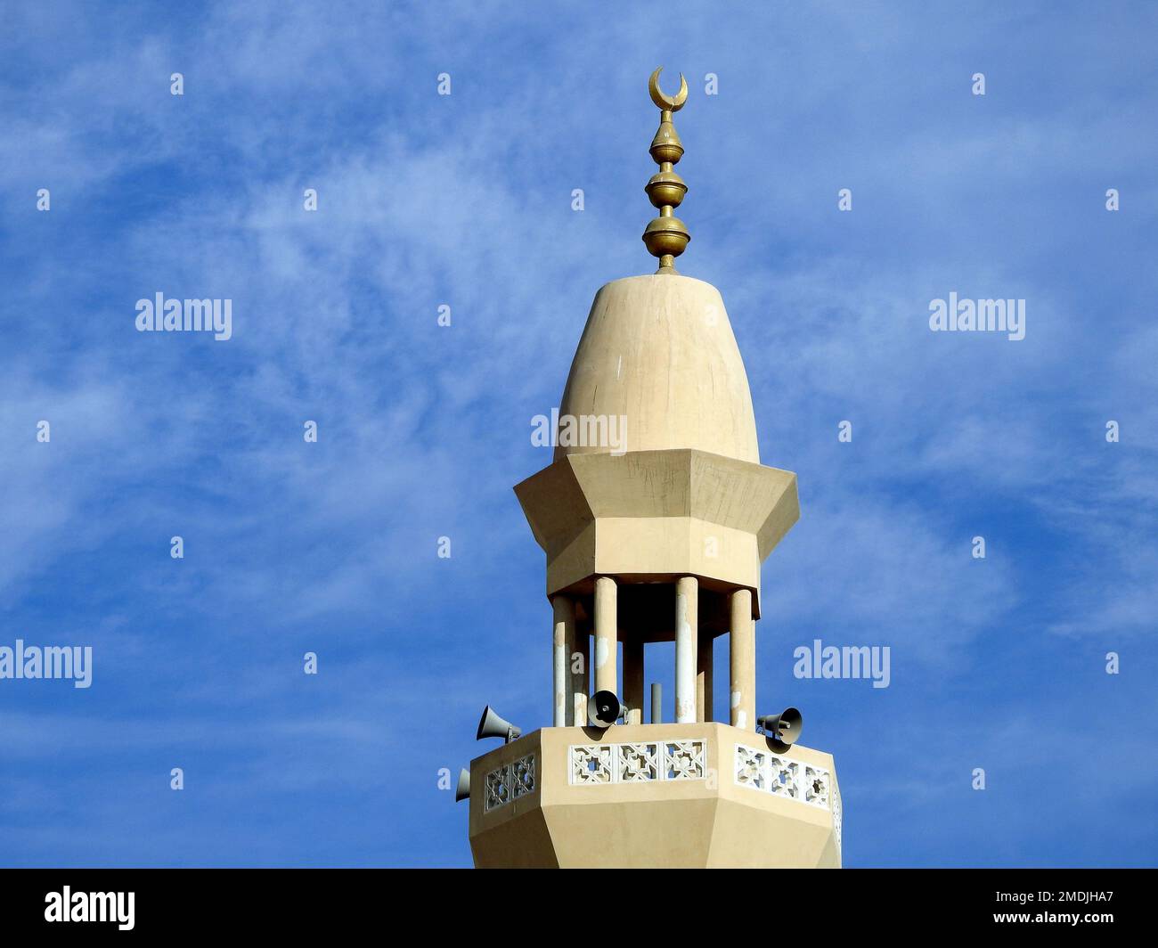 Un alto minareto di una moschea contro un bel cielo blu con nuvole alla luce del giorno, le Moschee sono il luogo di culto e di preghiere per i musulmani dove loro Foto Stock