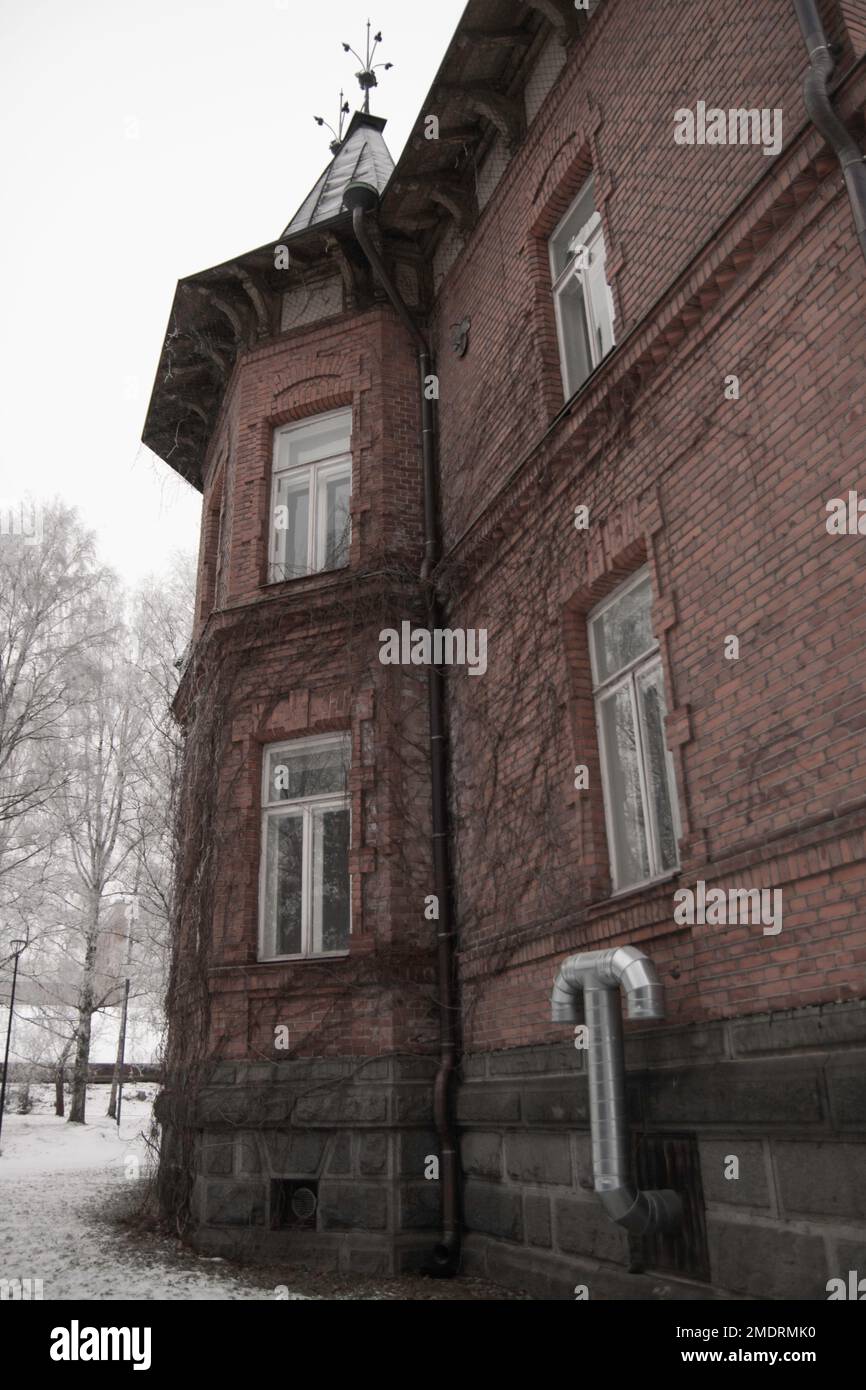 Fotografa in un'antica fabbrica, le pareti dell'arte Graffiti, i vecchi edifici industriali e il clima invernale gelido. Neve a terra Foto Stock