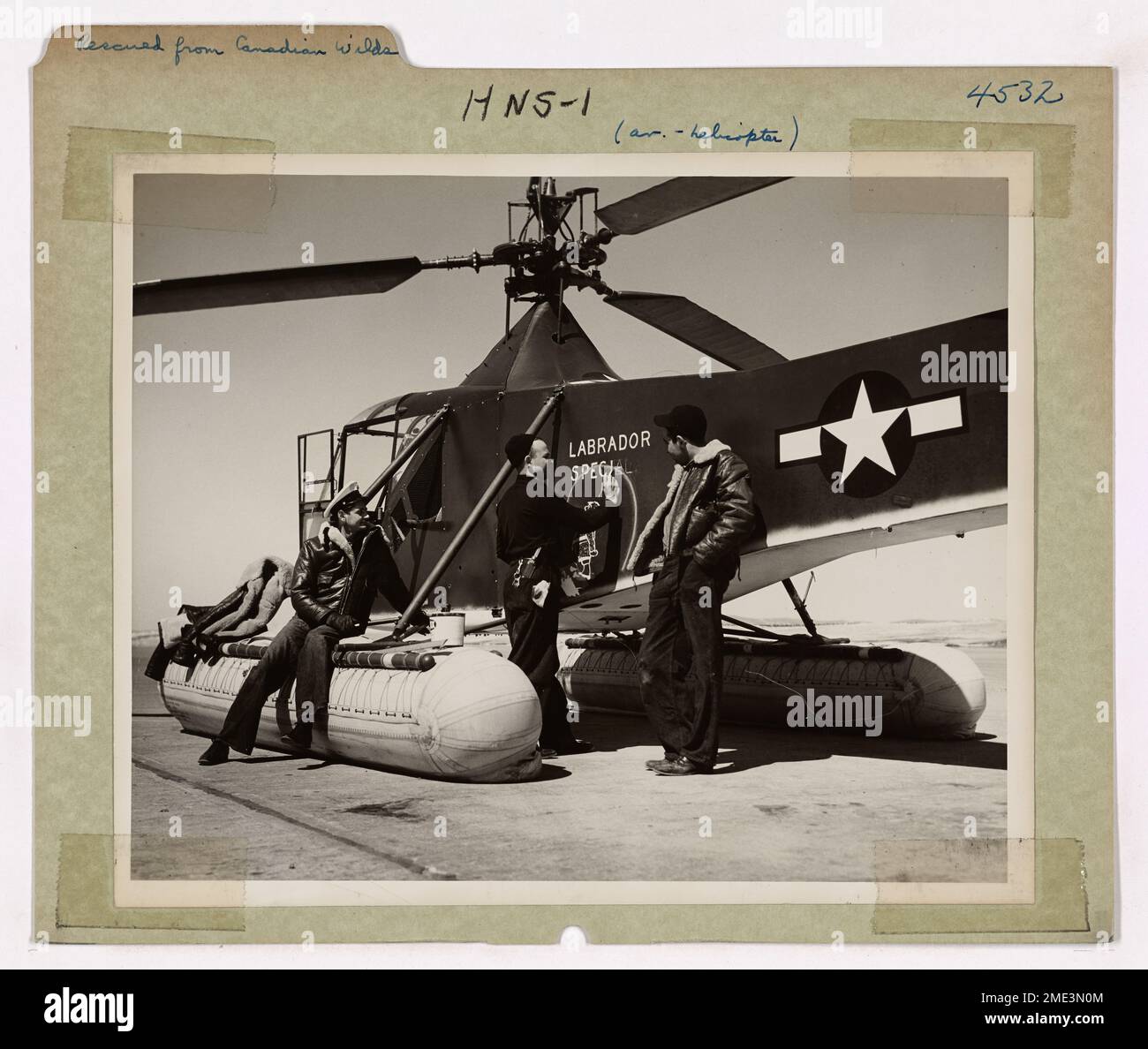 Brooklyn Coast Guardsman aiuta a salvare 11 Airmen canadesi da Labrador Wilds. Coast Guardsman Gus Jablonski, Aviation Machinist's Mate First Class, di Brooklyn, N.Y., dipinge un cartello 'Labrador Special' sull'elicottero della Guardia Costiera che ha sollevato 11 persone della Royal Canadian Air Force da una trappola d'urto nella desolata solidità del North Labrador. L'elicottero ha fatto 11 voli da un campo di salvataggio a 32 miglia di distanza alla scena di incidente per far uscire le vittime uno ad uno. L'elicottero della Guardia Costiera è stato volato in un aereo di comando di trasporto aereo per Goose Bay, Labrador, dove Coast Guardsman Jablonski h Foto Stock