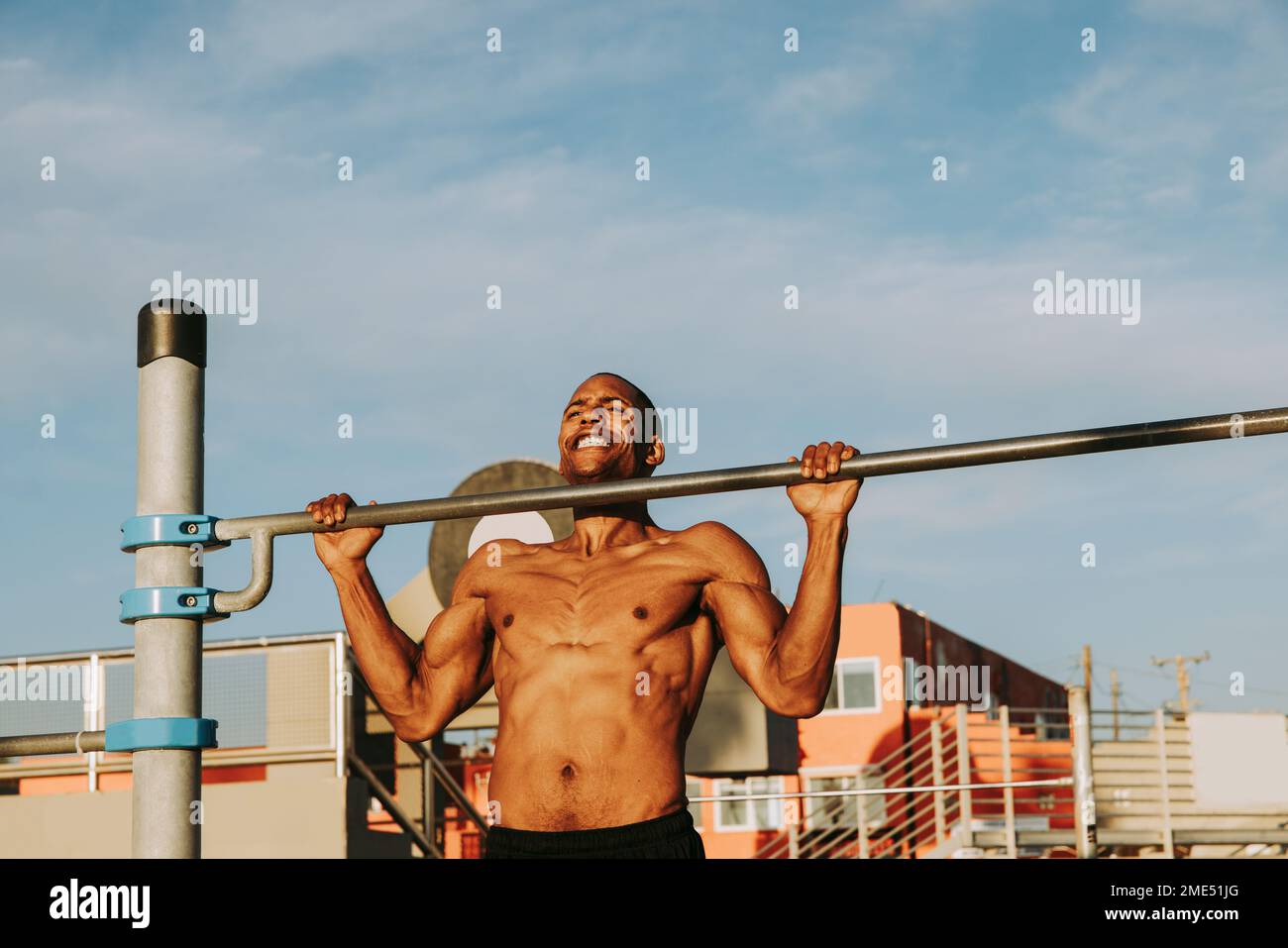 Uomo attivo che si esercita sulla barra di ginnastica Foto Stock