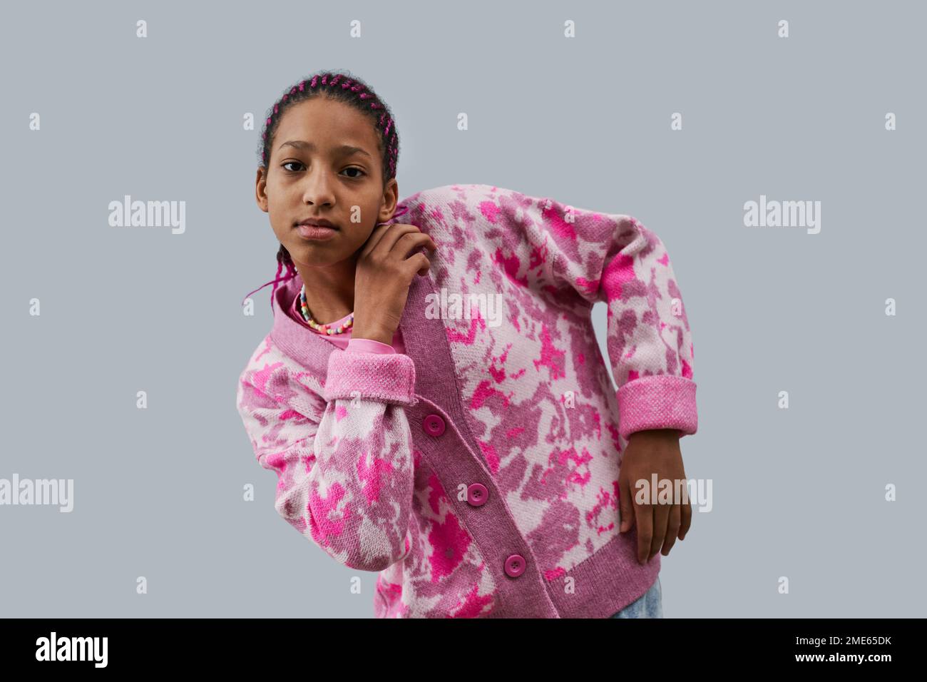 Vita in su ritratto di ragazza adolescente nera che indossa abiti rosa alla moda posa stile su sfondo blu Foto Stock