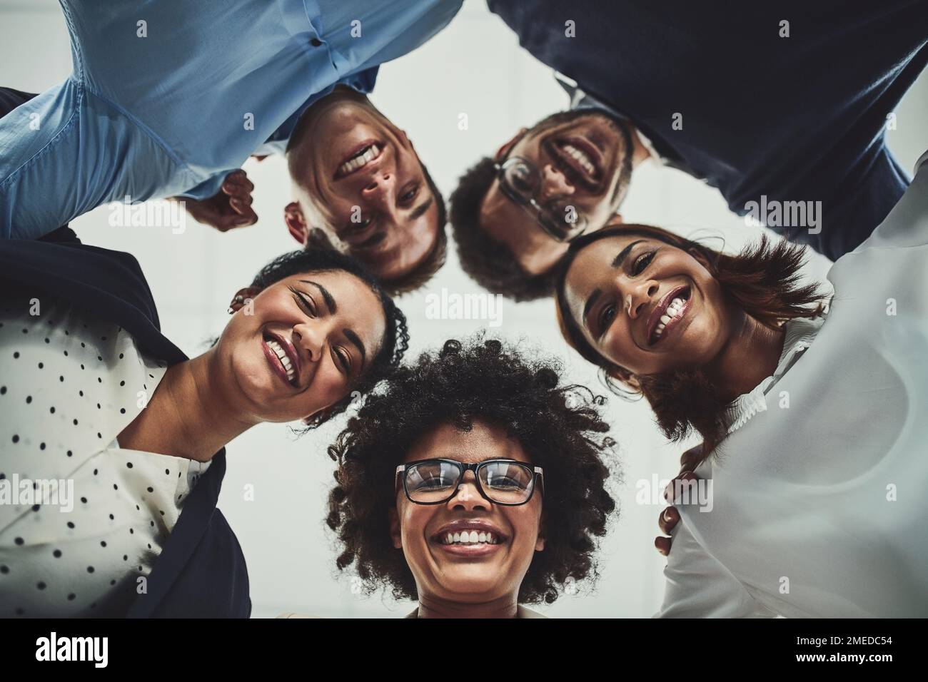 Sappiamo solo come prendersi cura del business. Ritratto di un gruppo di uomini d'affari che mettono la testa insieme in una beffa. Foto Stock