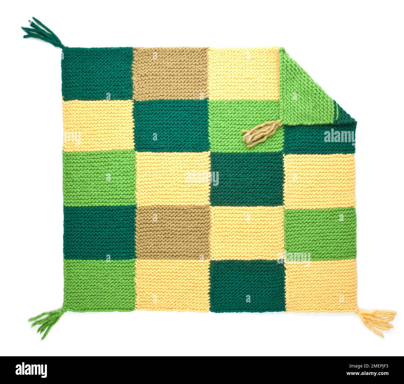 Coperta in lana di alpaca lavorata a maglia con nappine su ogni angolo Foto Stock