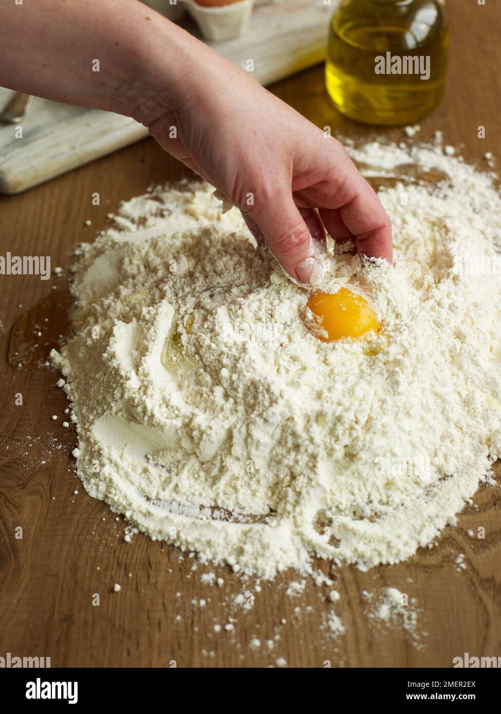 La miscelazione di uovo, olio di oliva e la farina (rendendo la pasta) Foto Stock