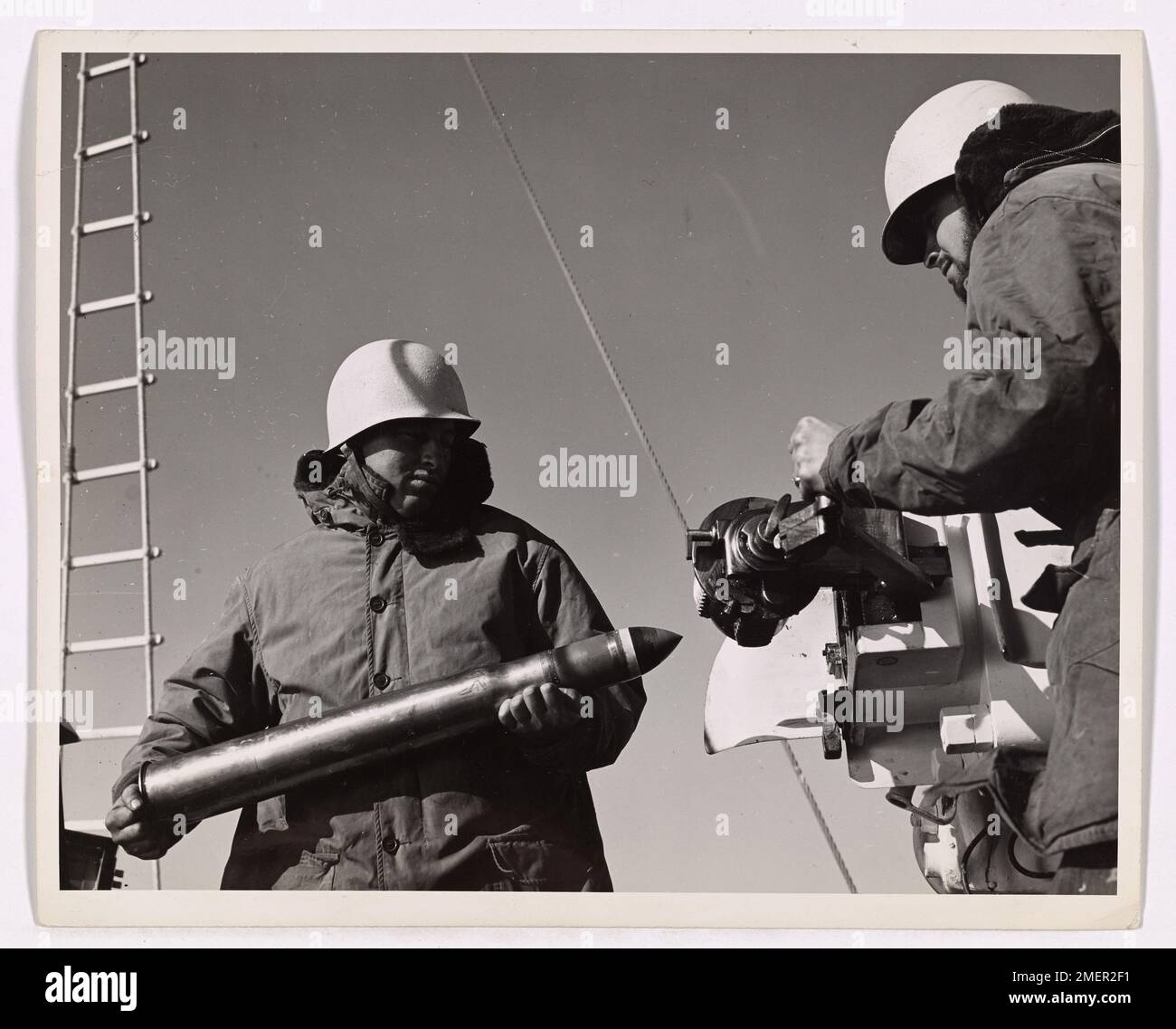 Le guardie costiere preparano la batteria principale durante un'esercitazione con armi da fuoco, garantendo la disponibilità per le operazioni navali e di battaglia. L'esercitazione mostra il loro ruolo nel mantenere la preparazione militare durante la guerra. Foto Stock