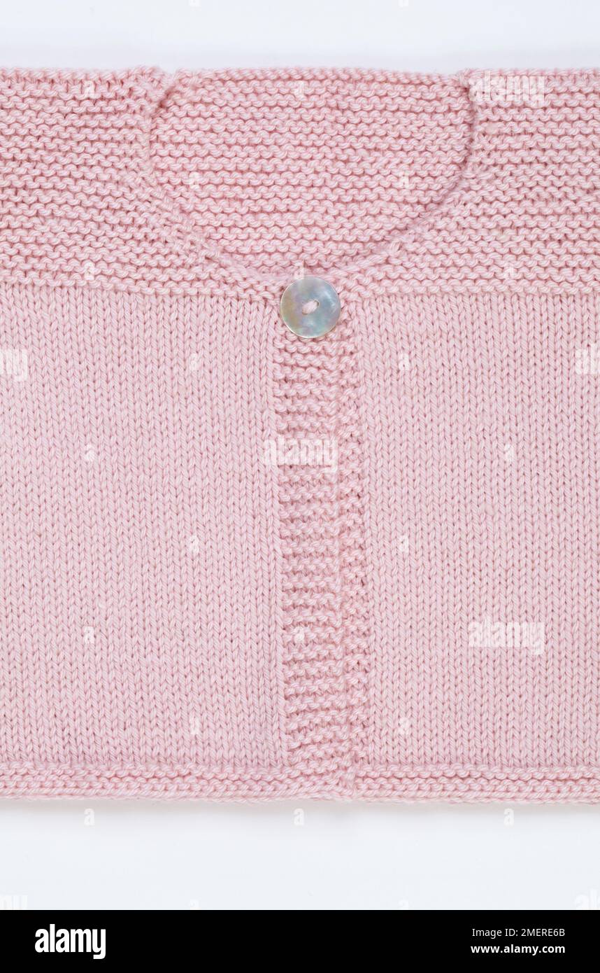 Cardigan rosa lavorato a maglia Foto Stock