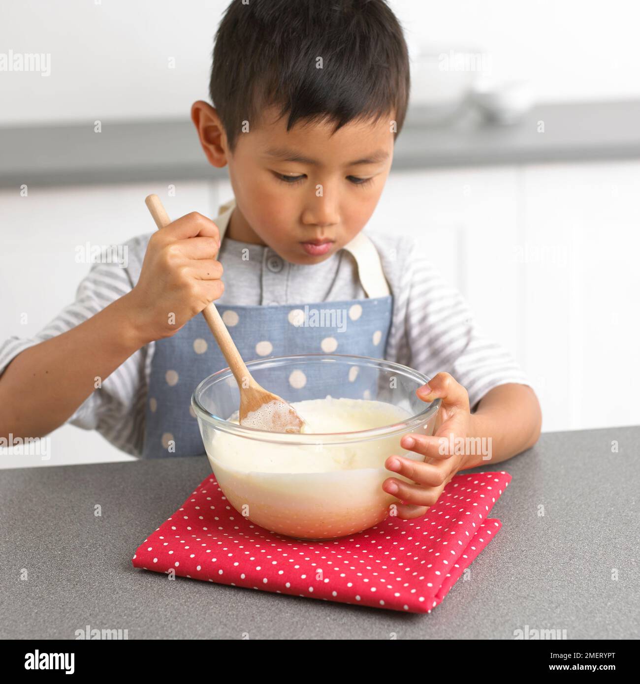 Rendendo il cioccolato bianco tartufi, ragazzo bianco di miscelazione miscela di cioccolato, 4 anni Foto Stock