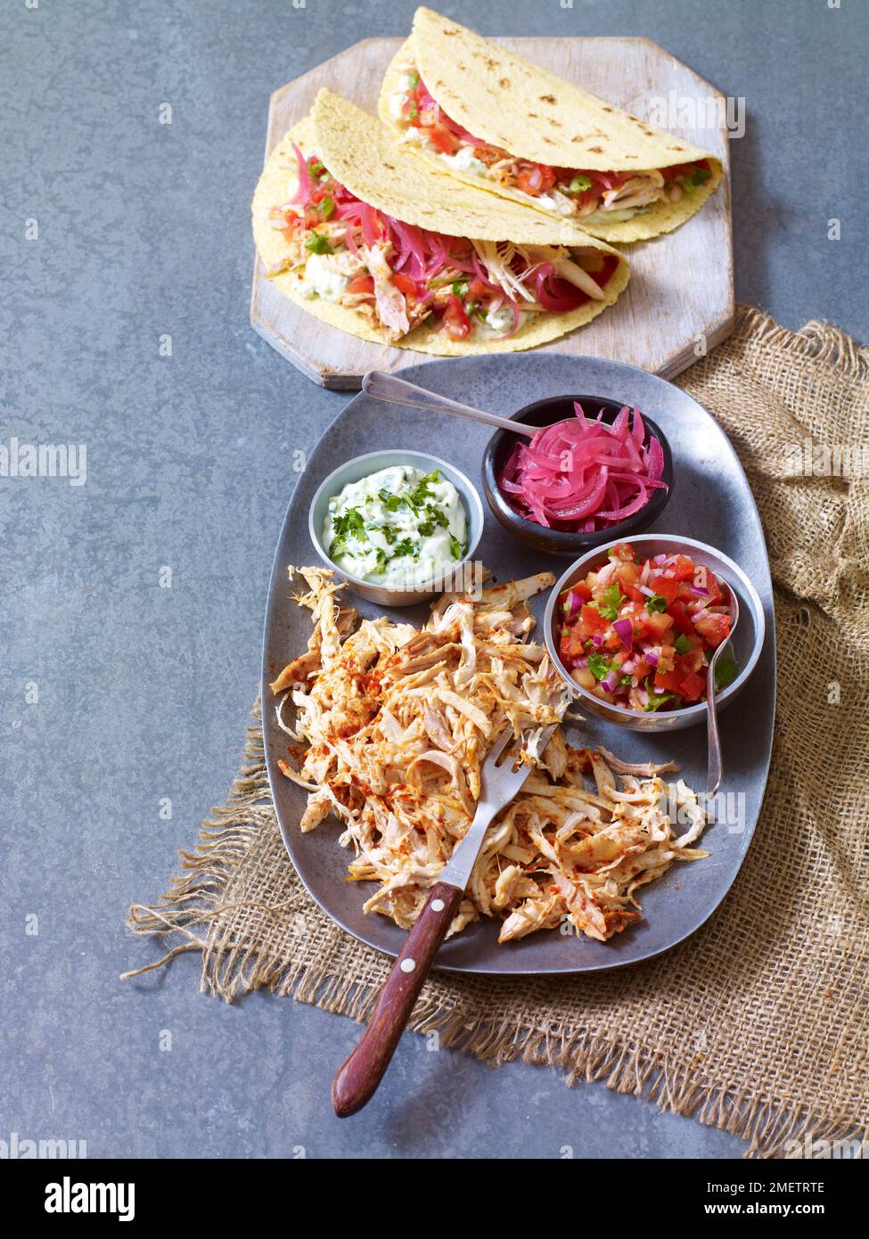 Taco di pollo tirato con salsa Pico de gallo, cipolle sottaceto e salsa all'avocado Foto Stock
