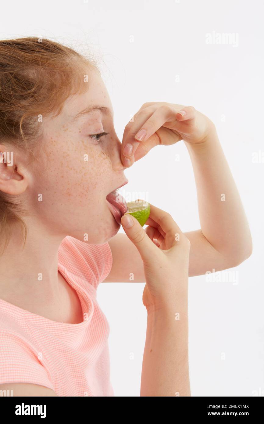 Cuneo di lime utilizzato per un test del gusto. Modello 10 anni. Foto Stock