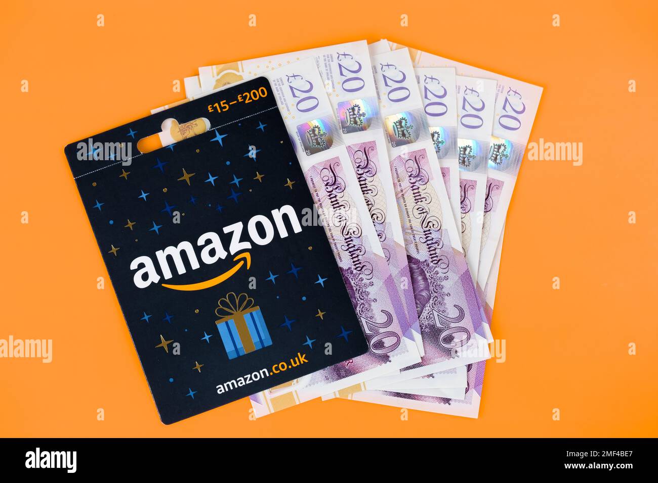 Carta regalo Amazon posta su un mucchio di contanti. Stafford, Regno Unito, 24 gennaio 2023 Foto Stock