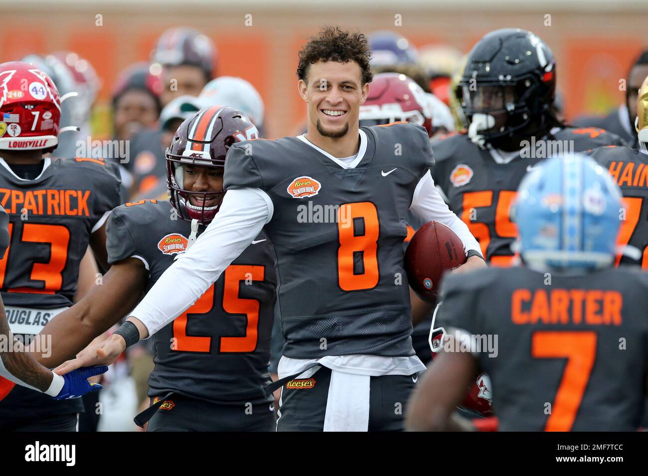 National Team quarterback Feleipe Franks of Arkansas (8) smiles on the sidelines during the second half of the NCAA college football Senior Bowl in Mobile, Ala, Saturday, Jan. 30, 2021. (AP Photo/Rusty Costanza) Foto Stock
