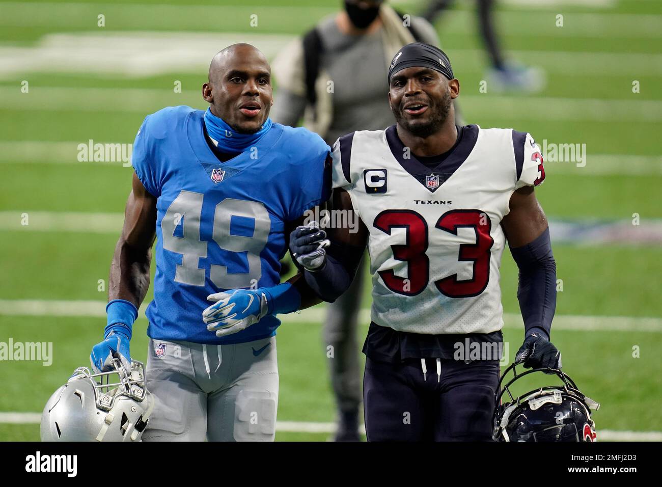 Detroit Lions safety C.J. Moore (49) and Houston Texans safety A.J. Moore (33) walk off the field after an NFL football game, Thursday, Nov. 26, 2020, in Detroit. (AP Photo/Paul Sancya) Foto Stock