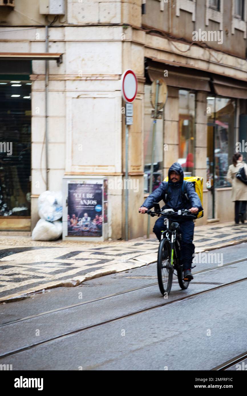 Consegna il cibo in bicicletta sotto la pioggia Foto Stock