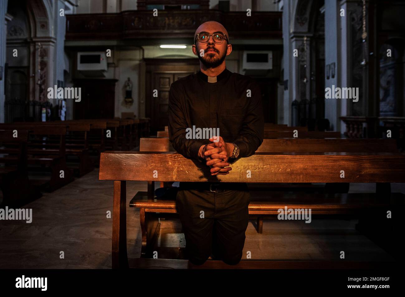 Seminarist Francesco Alberti prays at the Fermo and Rustico Saints church in Cusago, Italy on