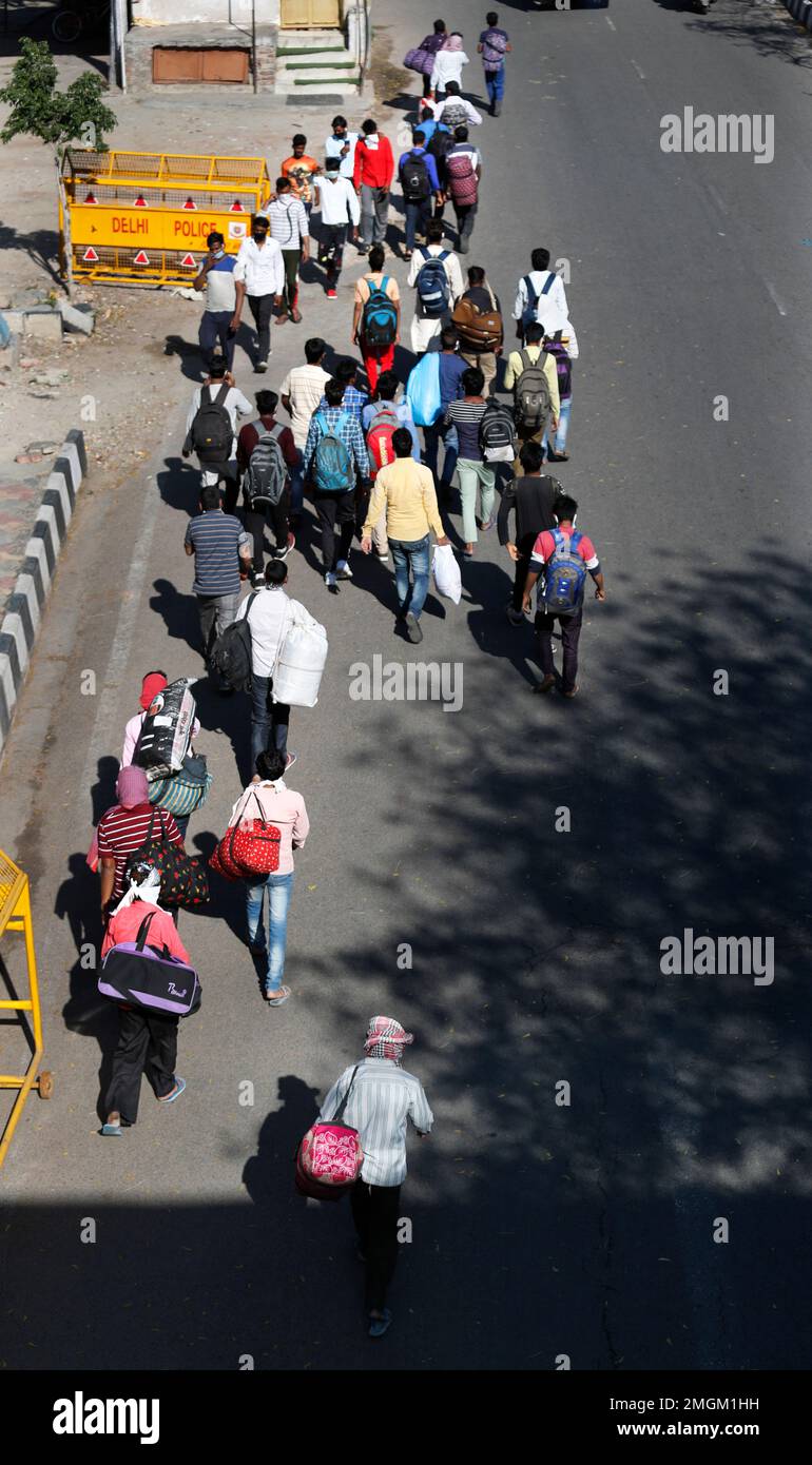 Migrant daily wage laborers make the journey to their respective ...