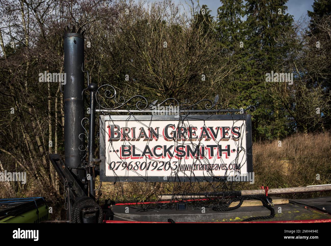 Brian Greaves fabbro artista che produce sculture dalla sua chiatta Bronte sui canali Yorkshire, qui a Gargrave sul canale Leeds Liverpool Foto Stock