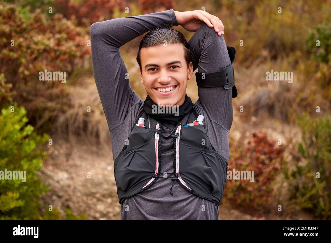 Stretching, fitness e ritratto dell'uomo in natura allenamento, esercizio o allenamento sportivo, runner o escursioni. Felice, trekking e muscolo caldo con Foto Stock