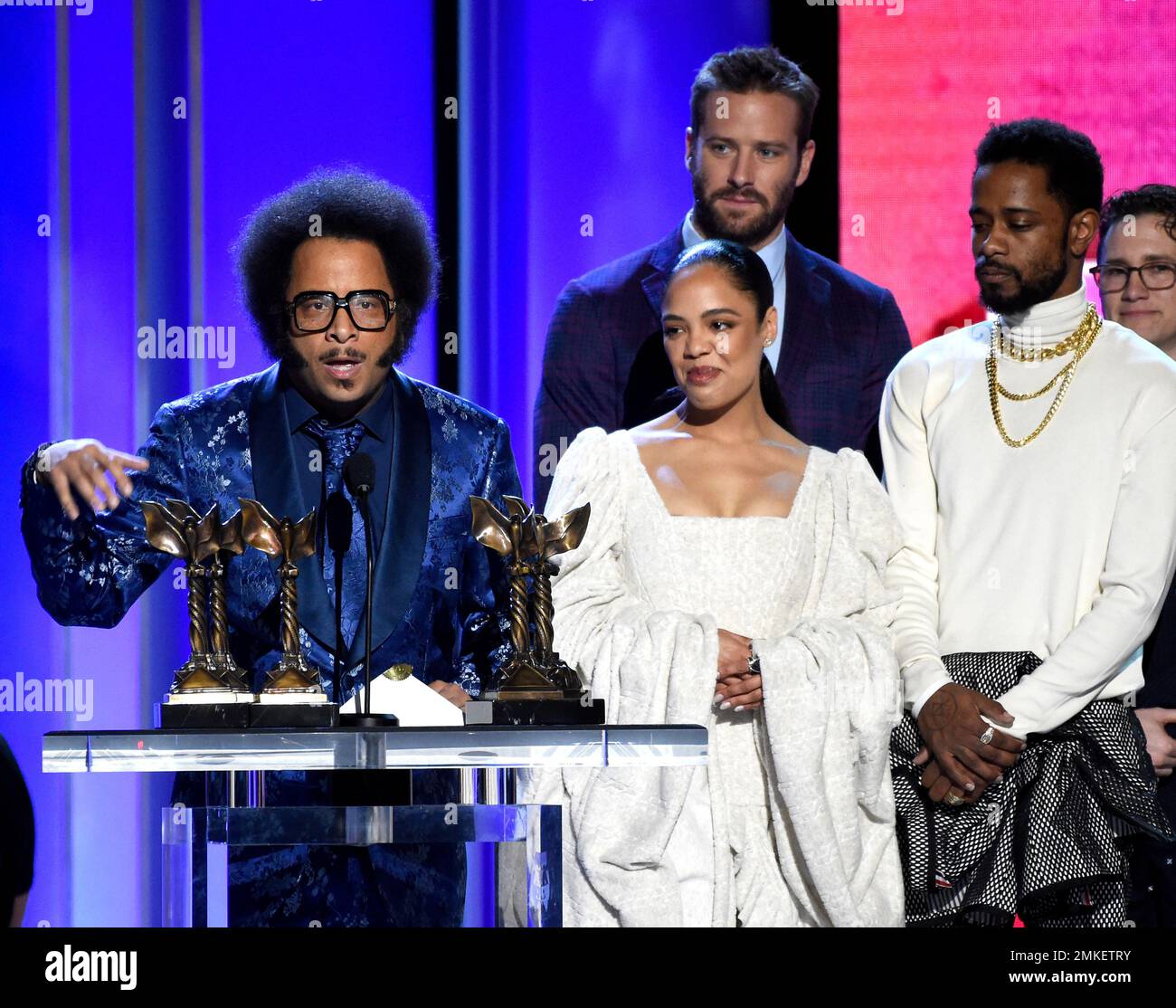 Boots Riley, left, accepts the award for best first feature for "Sorry