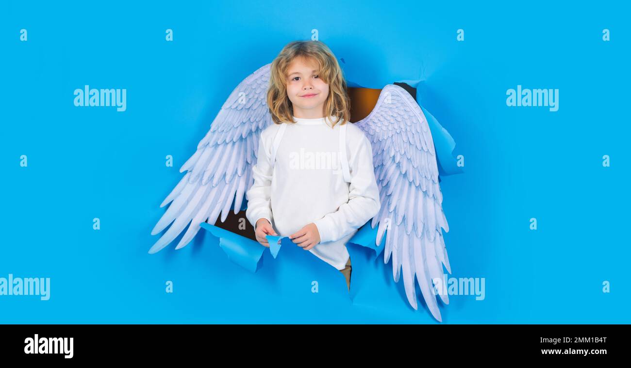 Banner di San Valentino. Cute bambino in ali bianche guardando attraverso il foro di carta. Ragazzo Cupido in costume d'angelo. Foto Stock