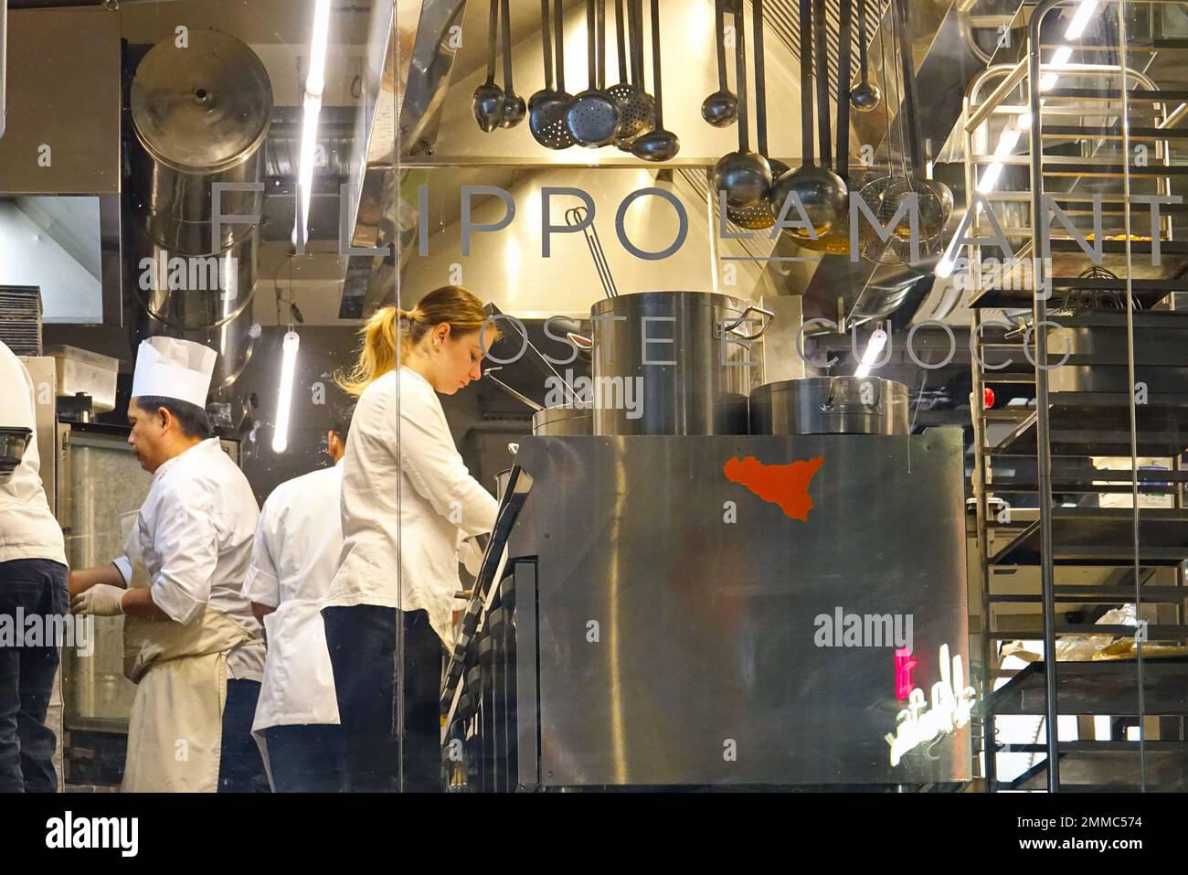 Gruppo di chef che lavorano in una cucina moderna del ristorante. Milano, Italia - Gennaio 2023 Foto Stock