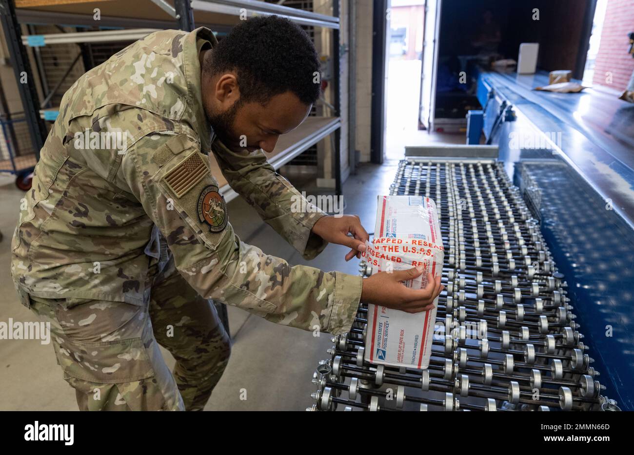 U.S. Air Force Senior Airman D’marco Wood, 100th impiegato postale militare Squadron di supporto della forza, assicura un pacchetto con nastro all'ufficio postale di Royal Air Force Mildenhall, Inghilterra, 21 settembre 2022. Gli impiegati postali gestiscono tutta la posta in arrivo e in uscita, che comprende l'organizzazione di lettere, pacchi e pacchi. Foto Stock