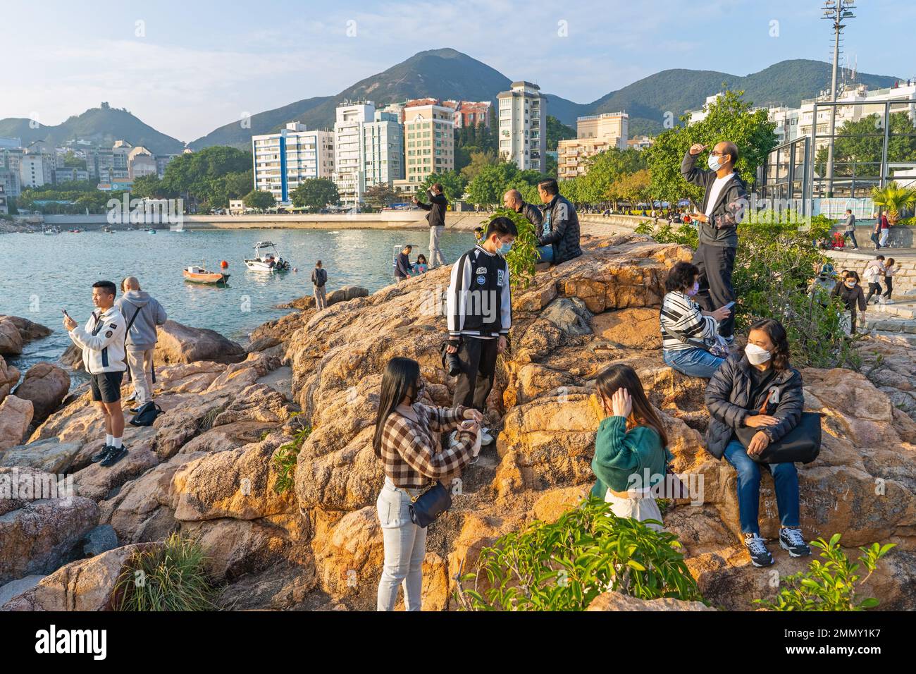 Hong Kong - Dicembre 2022 - persone che si godono il tramonto sulla spiaggia principale di Stanley Foto Stock