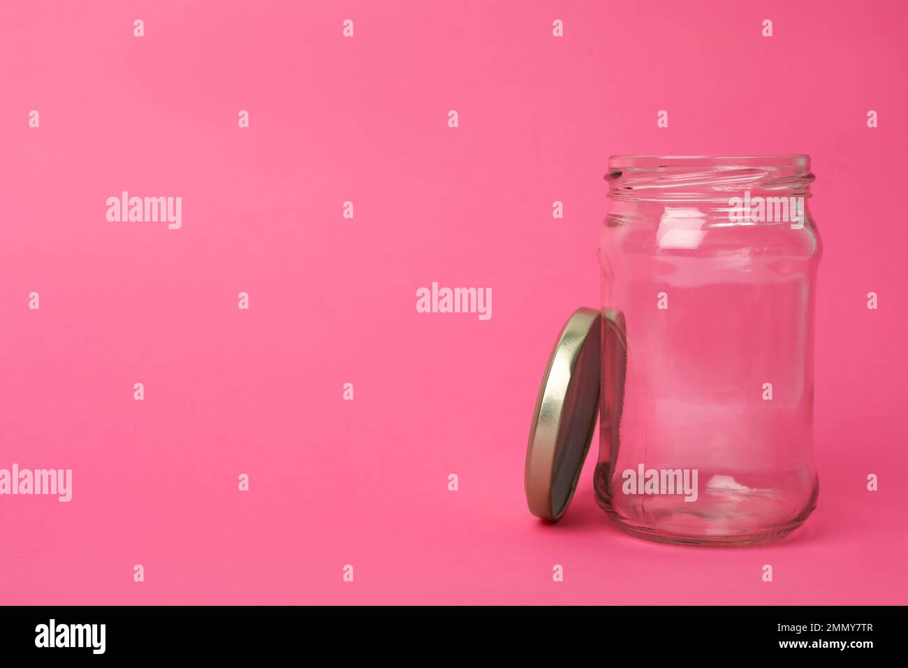 Aprire il vaso di vetro vuoto su sfondo rosa, spazio per il testo Foto Stock